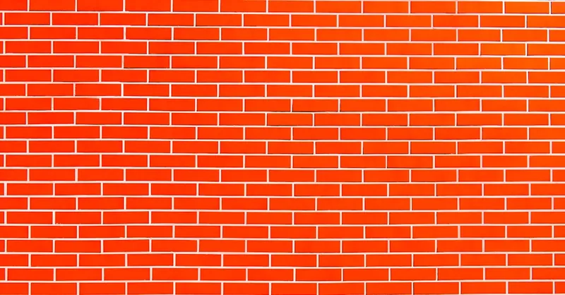 Vivid red brick wall perfect for architectural backgrounds and textural design projects.