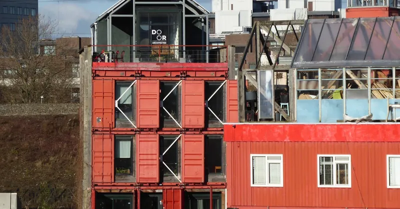 Unique shipping container buildings in Amsterdam showcasing innovative urban architecture.