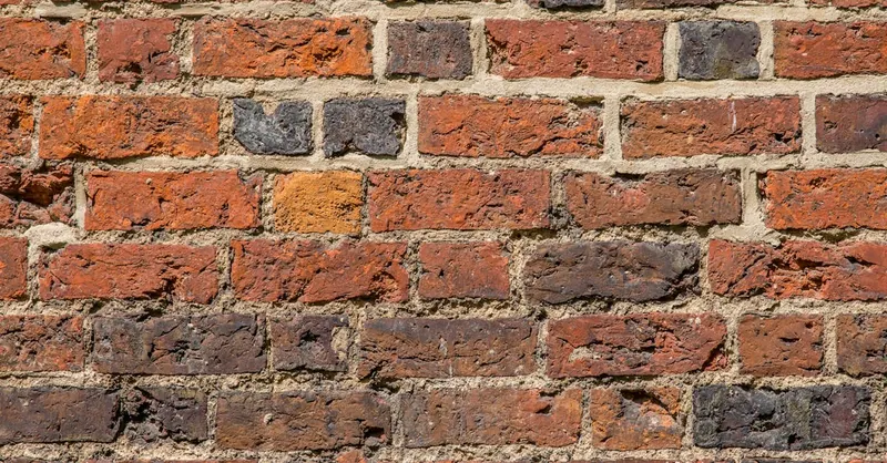Detailed image of a red brick wall showcasing texture and pattern.