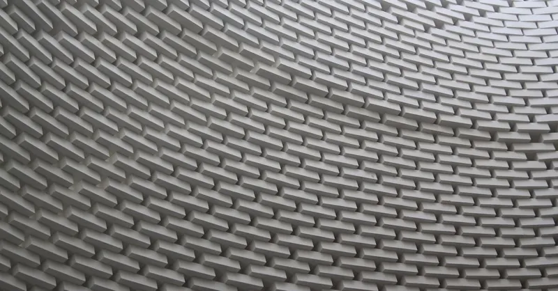 Abstract view of a wavy brick wall showcasing intricate architecture and design.