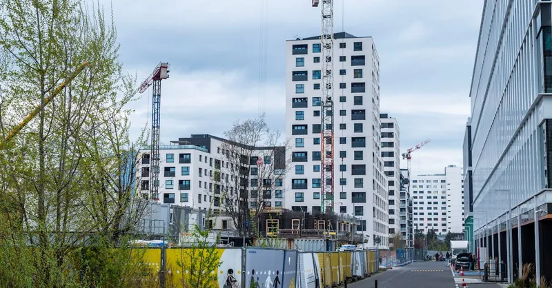 High-rise buildings and cranes in an urban construction site. Modern architecture.